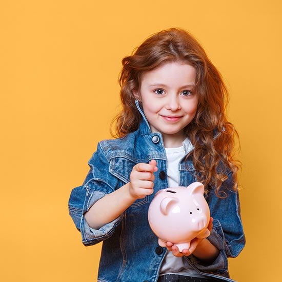 Opening-Accounts-feature. Little girl holding a piggy bank ready to put coins in it.