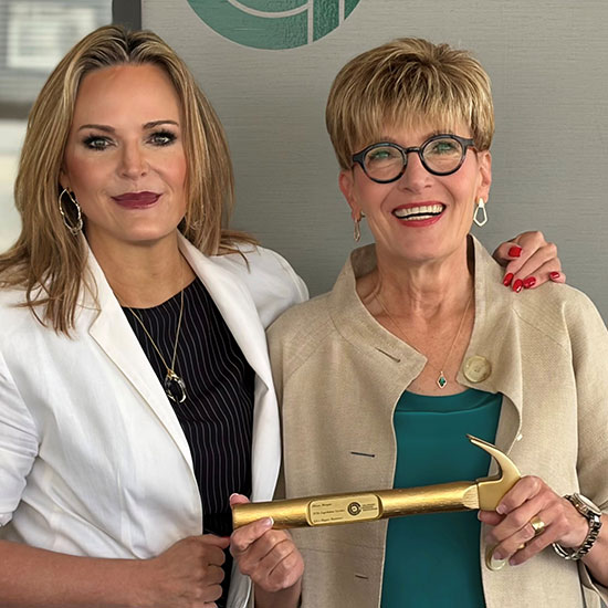 Alison-Morgan-FEATURE receiving the golden hammer